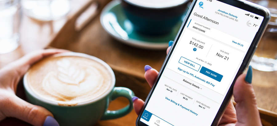 person holding coffee cup looking at account