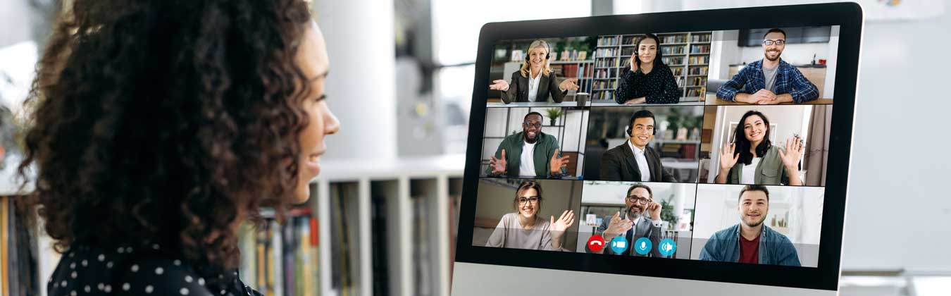 Woman sitting on desk attending webinar