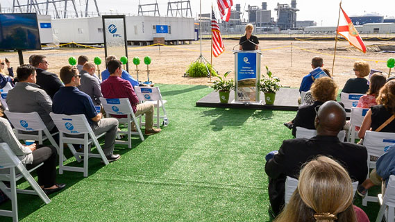 a speaker addressing a seated group of people at an fpl site