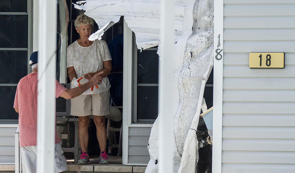 Customers clearing debris after Hurricane Ian