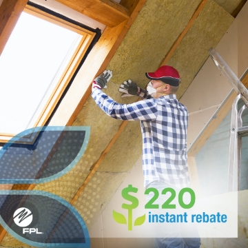 man in proper personal protection equipment installing ceiling insulation rolls