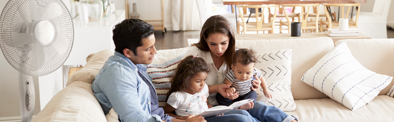 family on a couch looking at an ipad