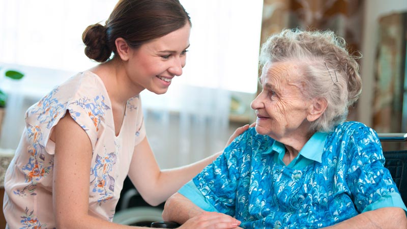 woman and senior sitting and smiling
