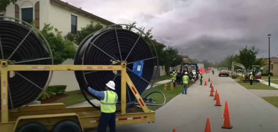 image of man standing amid hurricane restoration efforts