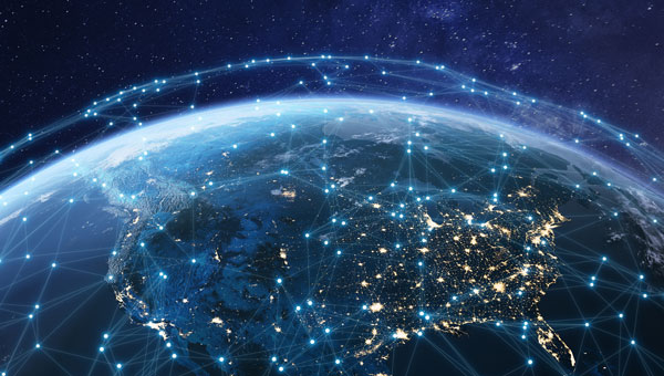 Digital network connections overlaying illuminated Earth showing global energy transmission infrastructure.