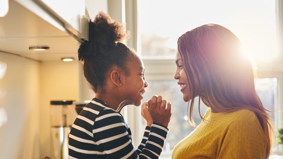 Mom and daughter smiling at each other