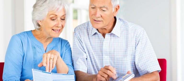 Older couple looking at a printed out bill