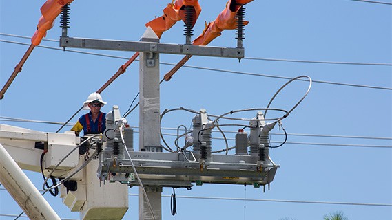 fpl worker in a bucket truck working on a power line