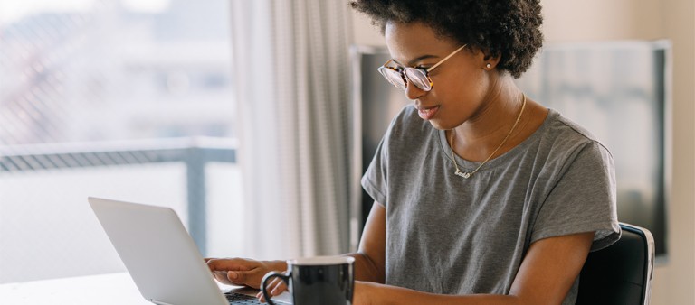 Woman sitting at a desk on her computer