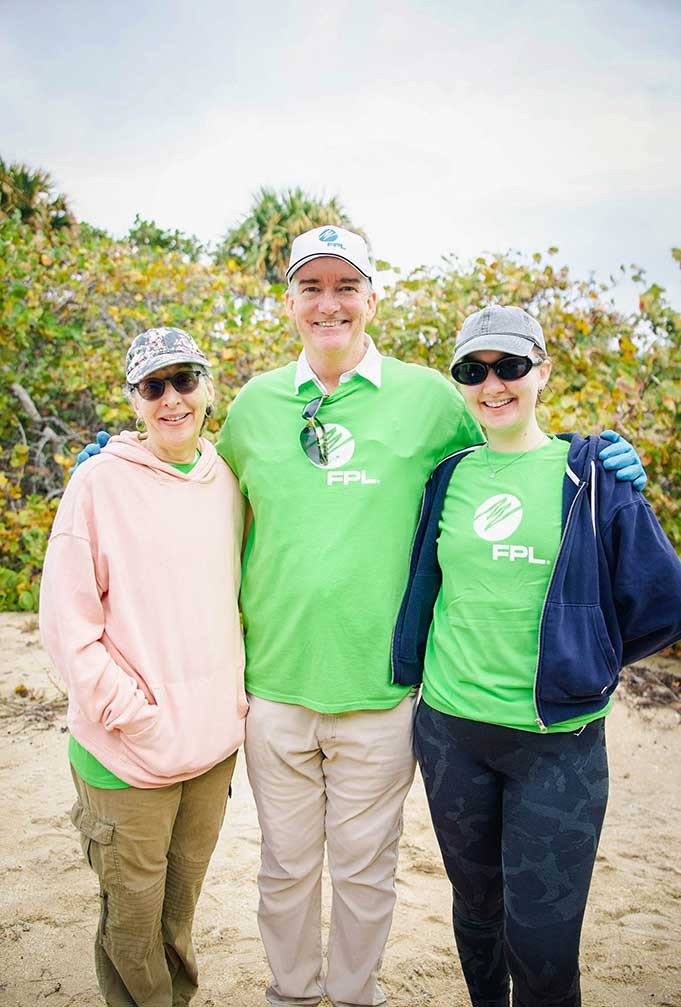 FPL employees smiling while at a beach cleanup