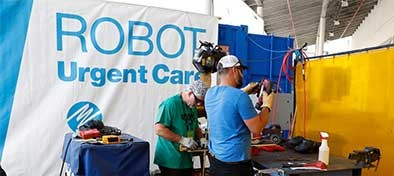 FPL employees fixing robots