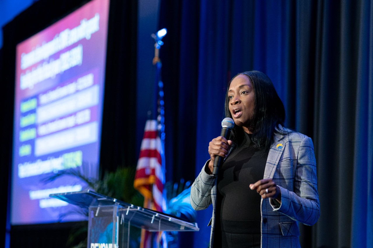 SWFL Symposium 2024 - speaker at podium