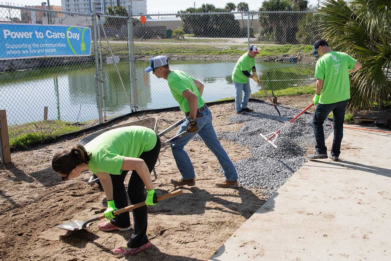 Volunteers shoveling rocks and dirt