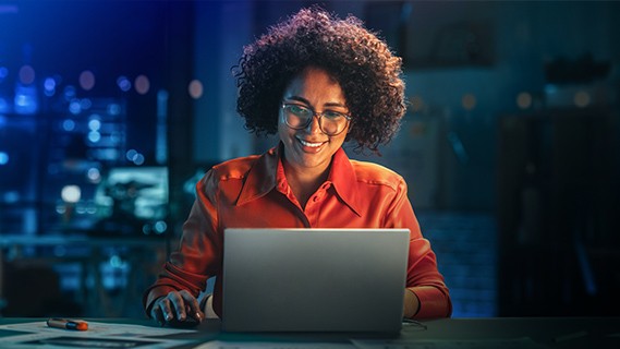 a woman sitting in front of her computer