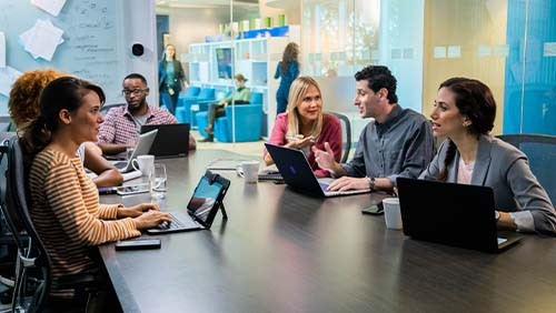 a group of employees having a discussion in a conference room