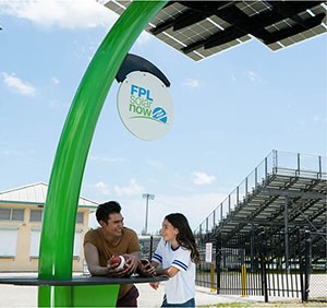A boy and girl talking underneath a solar tree