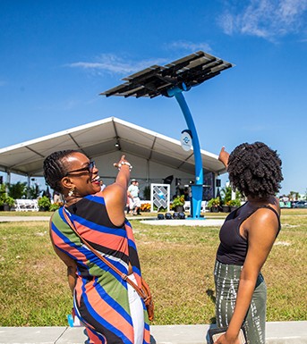 two female visitors point at the solar trees at Port Canaveral
