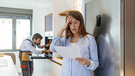woman upset while looking at paper