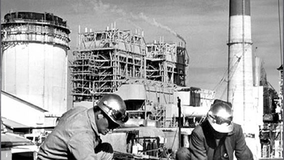 black and white image of fpl workers at a plant