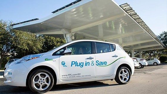 an electric vehicle parked in front of a covered parking lot