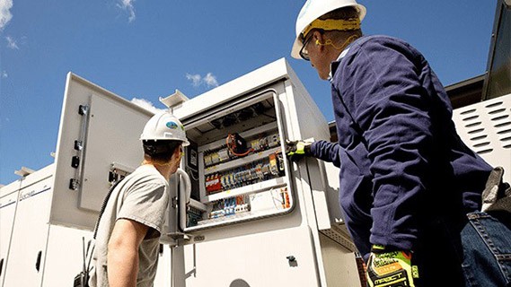 two fpl workers assessing an electrical system