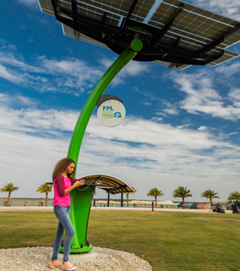 Woman on phone under a FPL solar tree
