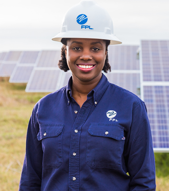 FPL employee smiling  in solar field