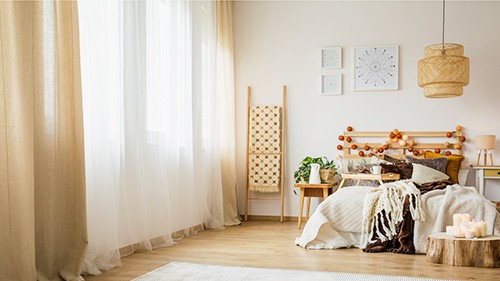 A bedroom with closed curtains
