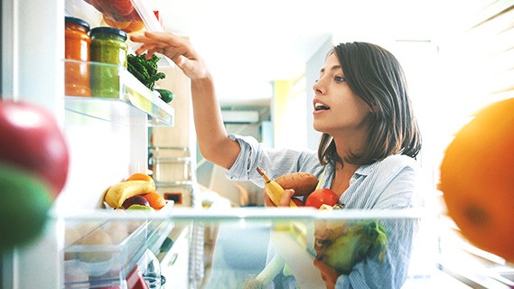 Woman looking into her fridge