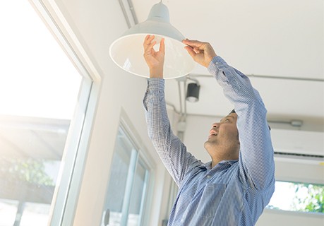 Man changing an LED light bulb