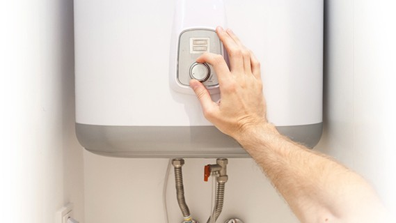 Hand adjusting a water heater