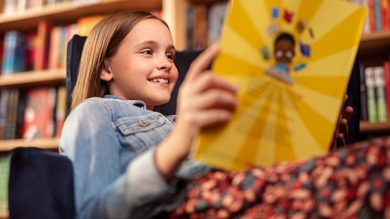 little girl with brown hair reading