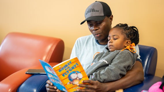 parent reading to child hooray for fly guy book