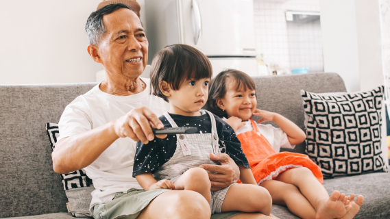 grandfather and two children on couch