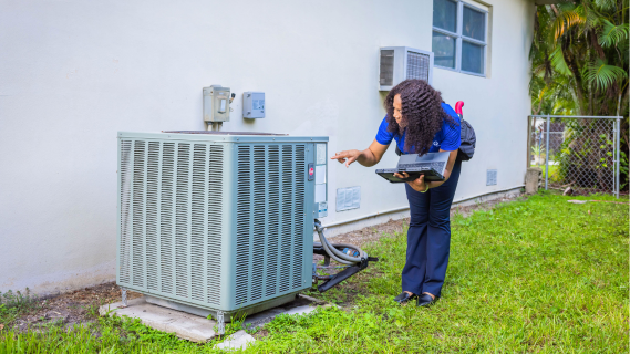 woman inspecting ac unit