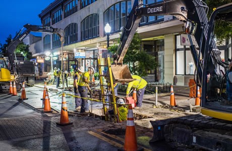 Crews working underground in downtown Pensacola at night