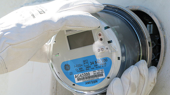 two gloved hands adjusting smart meter