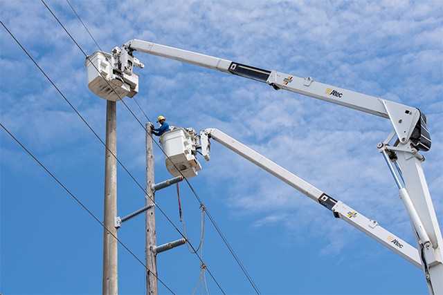 employee fixing the power lines