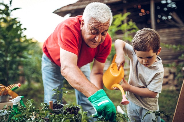 a grandfather and grandson playing in the garden