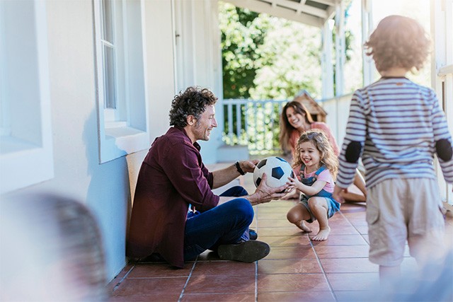 happy family having fun and playing on the porch