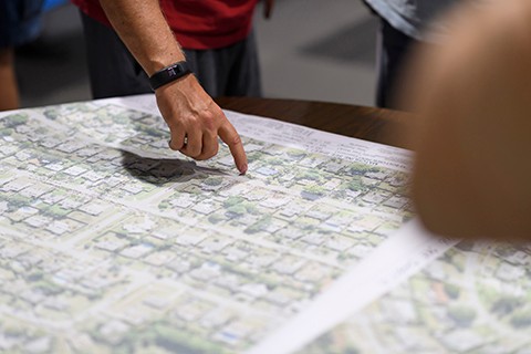person pointing to map