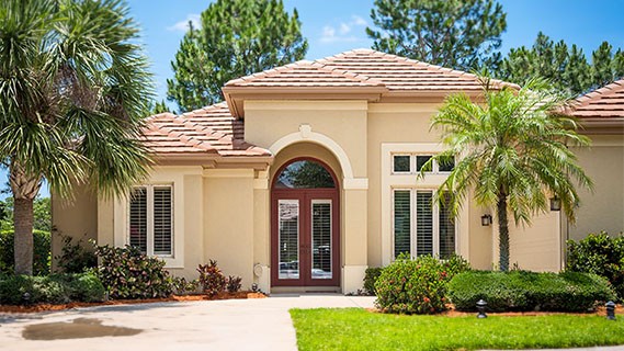front view of a single story home with a pathway and front yard