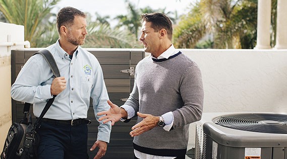 two men near ac unit