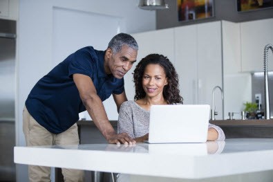 couple looking at laptop for energy survey