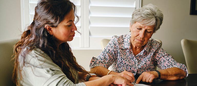 woman helping senior